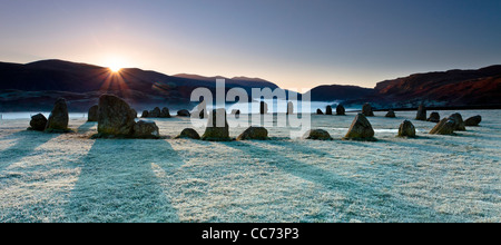 The stone circle of Castlerigg on a frosty morning as the first rays of light appear over the hills. Stock Photo