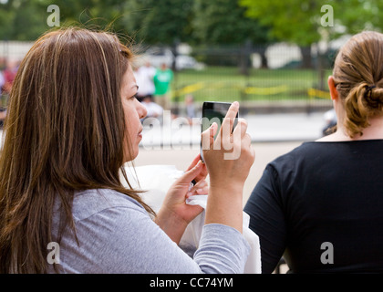 A woman taking video with a tablet PC - USA Stock Photo