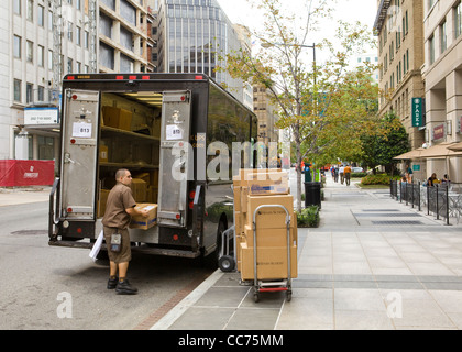 UPS delivery man unloading packages from truck - Washington, DC USA Stock Photo