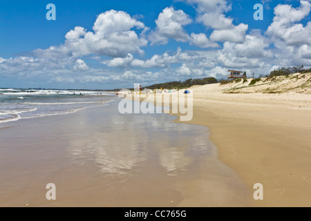 Lonely beach with distant swimmers on Coolum Beach, Sunshine Coast, Queensland Australia. Stock Photo