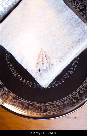 https://l450v.alamy.com/450v/cc76fd/luxury-towel-in-silver-scale-on-wooden-table-cc76fd.jpg