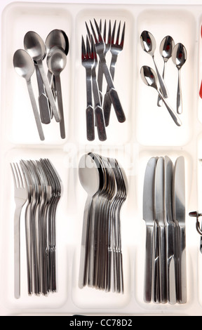 Various types of cutlery, kitchen tools, devices. In a drawer box, cutlery box. Stock Photo