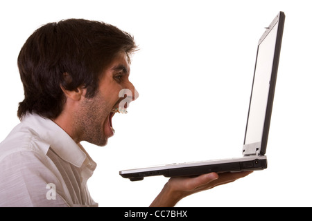 one young men screaming with his computer (isolated on white) Stock Photo