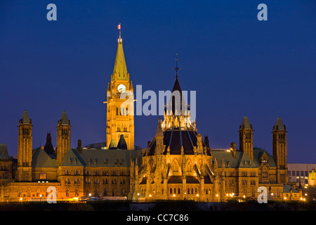 View of Parliament Hill seen from Nepean Point at dusk in the city of Ottawa, Ontario, Canada. Stock Photo