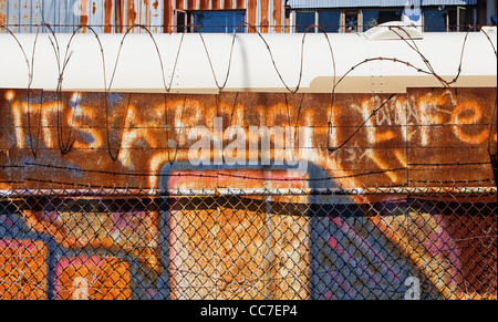 it's a rough life graffiti painted on rusted metal wall Stock Photo