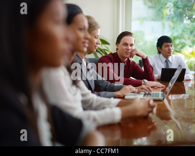 young business man working as manager and smiling at camera during meeting with colleagues Stock Photo
