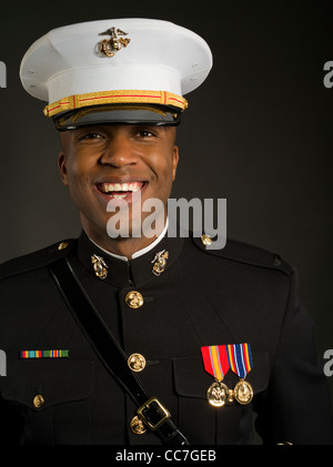 United States Marine Corps Officer in Blue Dress 'A' Uniform including medals ribbons white gloves, barracks cover ( hat ) sword Stock Photo