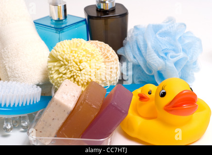 Bath towels, soap bars, sponges and rubber ducks. Stock Photo