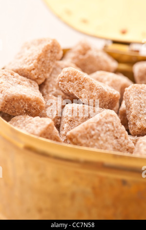 Sugar bowl filled with brown sugar cubes Stock Photo