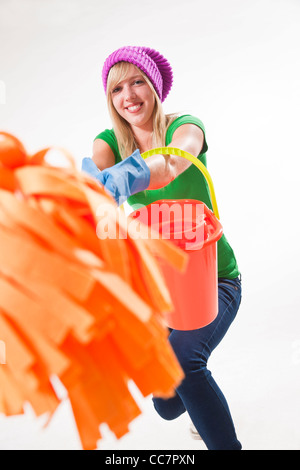 Portrait of Young Woman with Cleaning Supplies Stock Photo