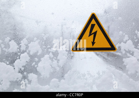 yellow sign high electricity beware Stock Photo