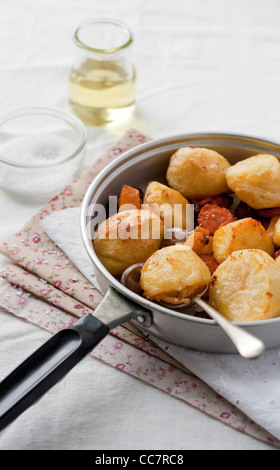Roast potatoes with garlic and carrots in a pan