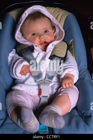 baby sitting in car safety seat Stock Photo