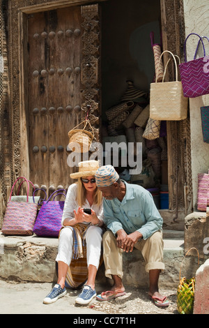 Basket Seller with Tourist, Stone Town, Unguja, Zanzibar, Tanzania Stock Photo
