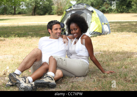 mixed couple camping Stock Photo