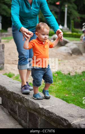 Mother and Son Walking on Stone Wall, Washington Park, Portland, Oregon, USA Stock Photo