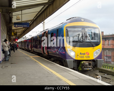 Platform 14 and a passenger train arriving at Manchester Piccadilly Station Stock Photo