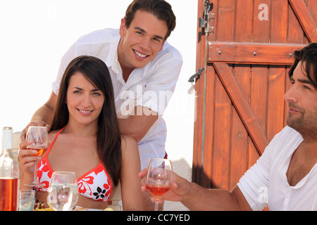 Friends drinking wine in the sunshine Stock Photo