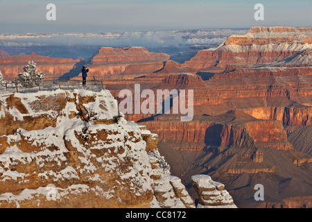 Photographer on canyon rim, winter view at Mather Point, South Rim of Grand Canyon National Park, Arizona, USA, Stock Photo