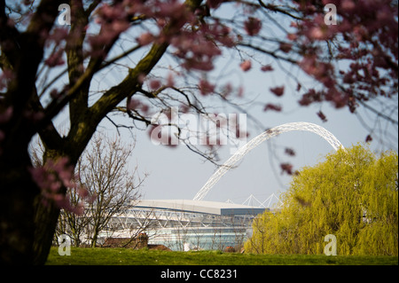 Wembley stadium seen in spring through the trees of Brent River Park in Brent a London borough Stock Photo