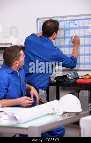 Laborers in office planning appointments Stock Photo
