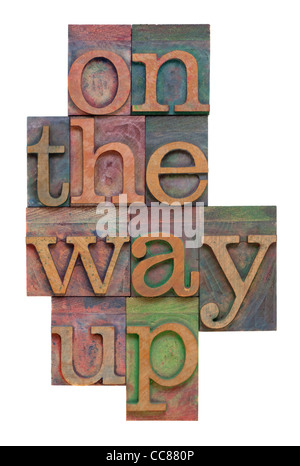 On the way up - phrase in vintage letterpress wooden printing blocks, stained by color inks, vertical layout, isolated on white Stock Photo