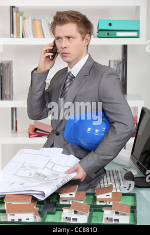 An annoyed architect talking on the phone Stock Photo