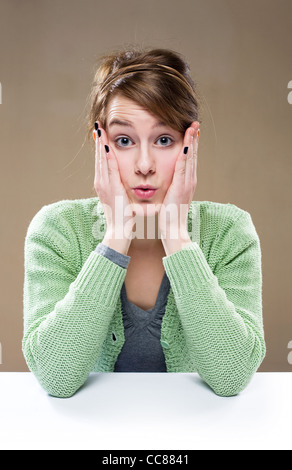 Portrait of a beautiful young brunette woman with shocked expression. Stock Photo