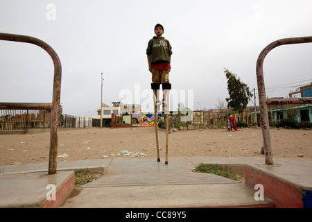 Youth practice walking on stilts in Lima, Peru, South America Stock Photo