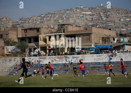 A football team competes on the pitch in Lima, Peru, South America. Stock Photo