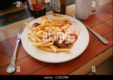 A fryup, fried breakfast, of bacon, egg and chips with tomato ketchup and a cup of tea in a riverside cafe, River Lea, Hertfordshire England Stock Photo