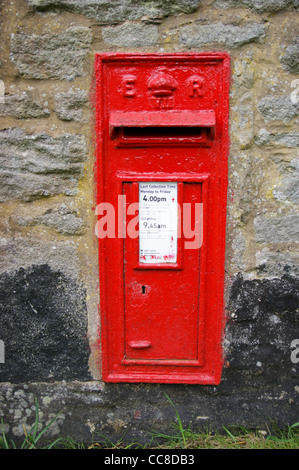 A red letterbox on a farm wall, Baldersdale, County Durham, England Stock Photo