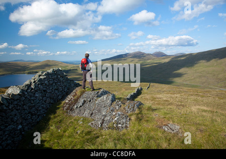 Walker looking towards the High Mournes from Pigeon Rock Mountain, Mourne Mountains, County Down, Northern Ireland. Stock Photo