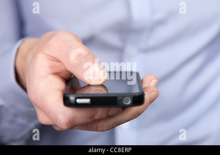 Businessman holding a smartphone in his hand Stock Photo