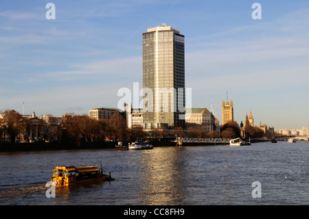 A Londonduck Amphibious tourist cruise vehicle on The Thames near Millbank Tower, London, England, UK Stock Photo