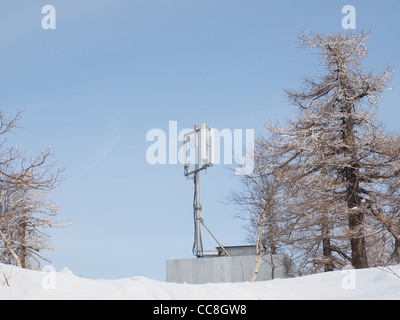Antenna on top of a mountain covered with snow Stock Photo