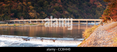 Panorama of the Katsura River and Togetsukyo Bridge at Arashiyama, on the western outskirts of Kyoto, Japan, in autumn. Stock Photo