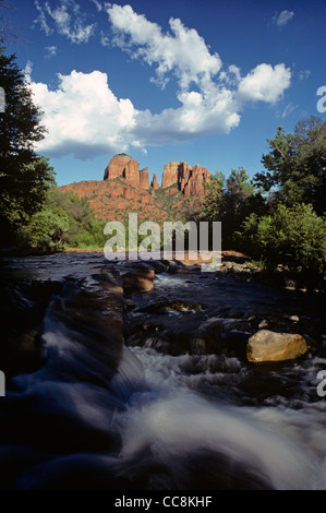 Cathedral Rocks from Oak Creek Canyon Red Rock Crossing with storm clouds over rock formations and small waterfall Stock Photo