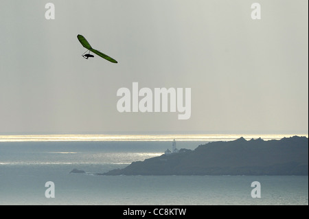 A hang glider uses the winds on the coast of South Devon on a winter morning. Stock Photo