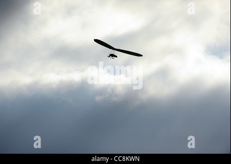 A hang glider uses the winds on the coast of South Devon on a winter morning. Stock Photo