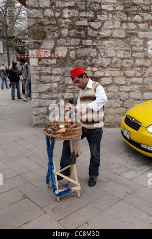 Turkish street vendor of sugar on a stick In the Old City Outside the walls of the Topkapi Palace Istanbul Turkey Stock Photo