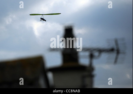 A hang glider uses the winds on the coast of South Devon on a winter morning. Stock Photo