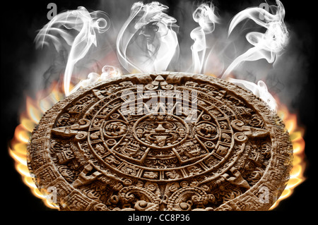 Apocalyptic Mayan Calendar on fire with smoke rising from its surface and 2012 written in smoke . On black background. Isolated Stock Photo