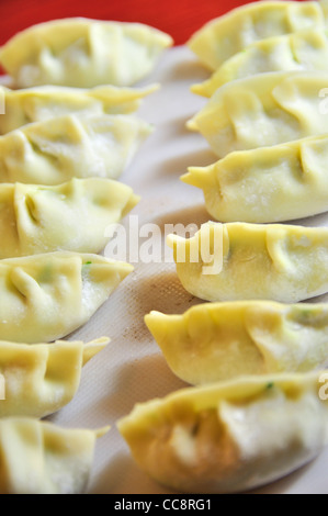 Making traditional dim sum Chinese dumplings in  kitchen, China. Stock Photo