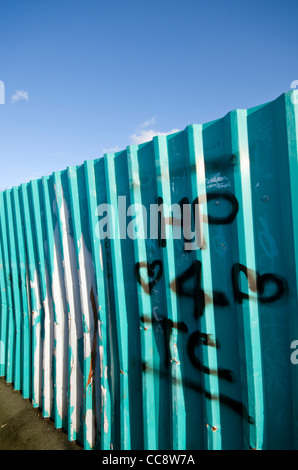 Graffiti on the side a blue railway bridge in Manchester, England, UK Stock Photo