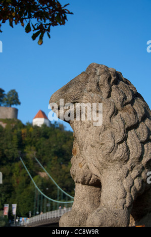 Germany, Passau. Lion statue in front of hilltop Veste Oberhaus (aka Upper Fortress), built from 1217 to 1803. Stock Photo
