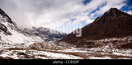 India, Arunachal Pradesh, hairpin bends up steep sloping road through mountains to Sela Pass, panoramic Stock Photo