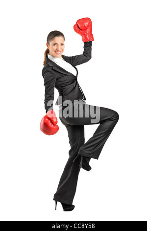 Full length portrait of a beautiful business woman wearing boxing gloves Stock Photo