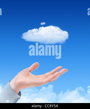 Man hand propose cloud against blue sky with clouds on background. Concept image on cloud computing and eco theme. Stock Photo