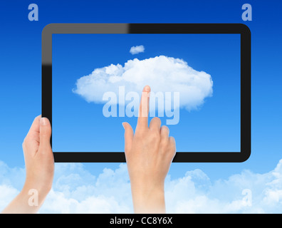 Woman hand holding black frame and touch the cloud against blue sky with clouds. Concept image on cloud computing theme. Stock Photo